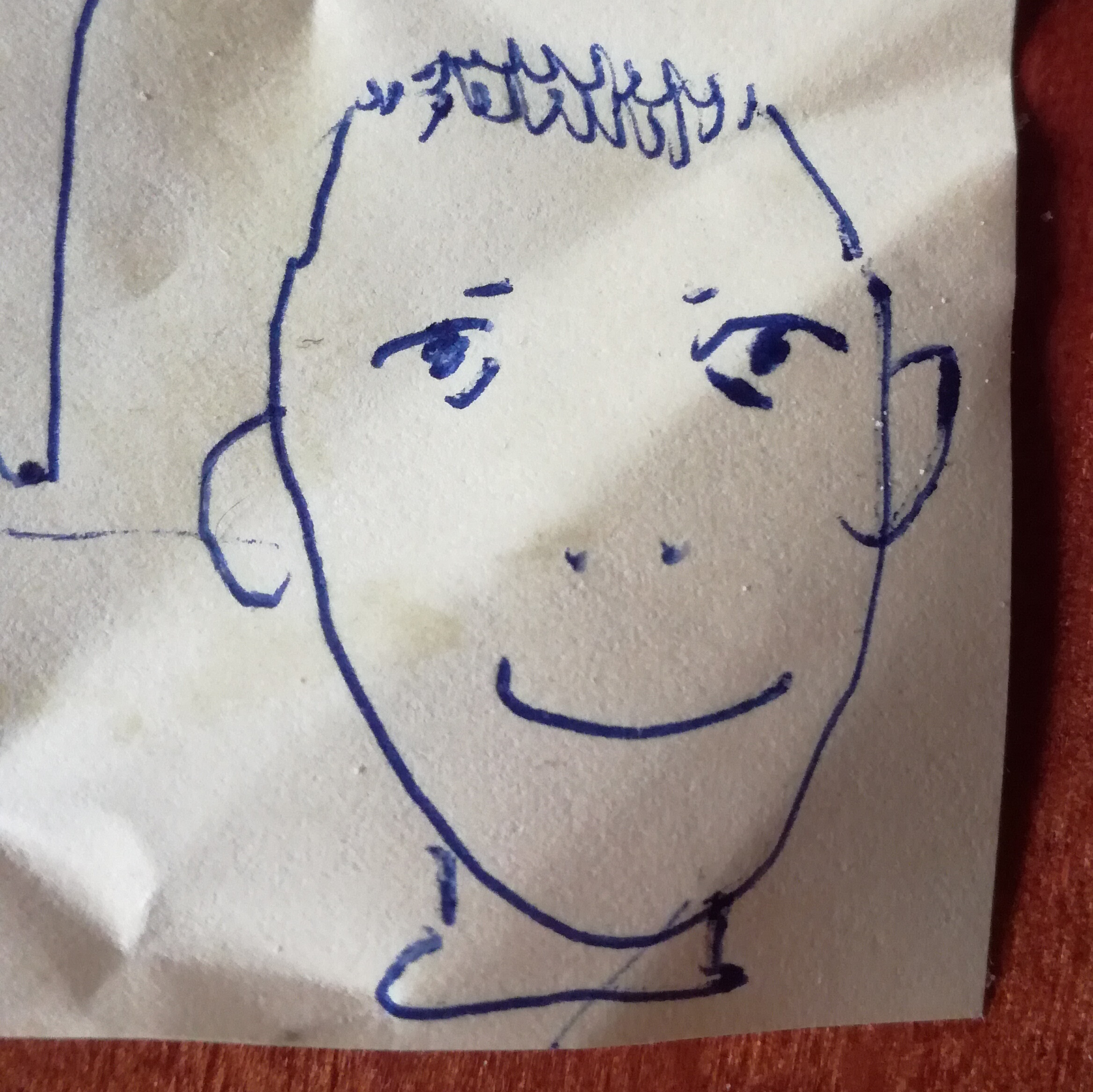 ballpoint pen drawing of a wonky face