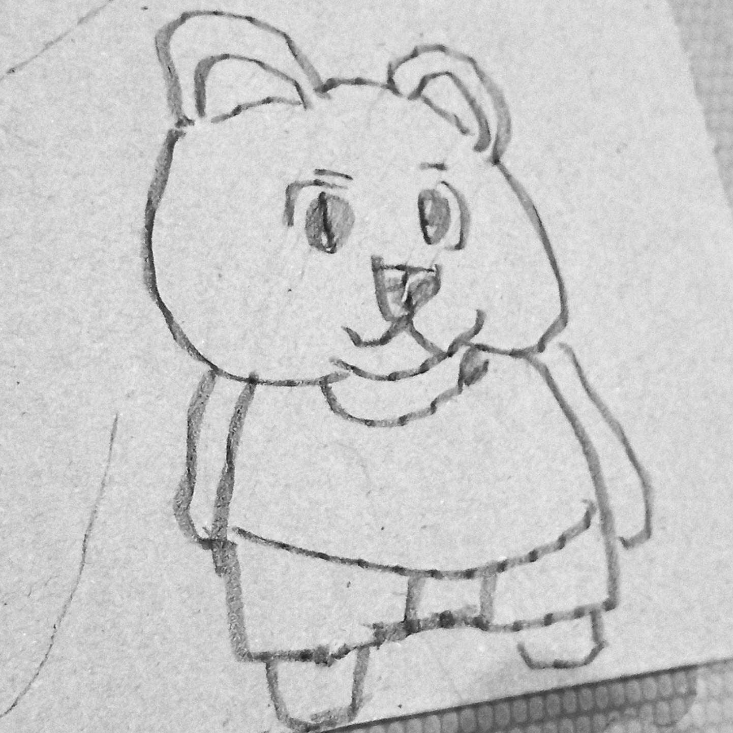 pencil sketch of a little antrho bear on a piece of cardboard